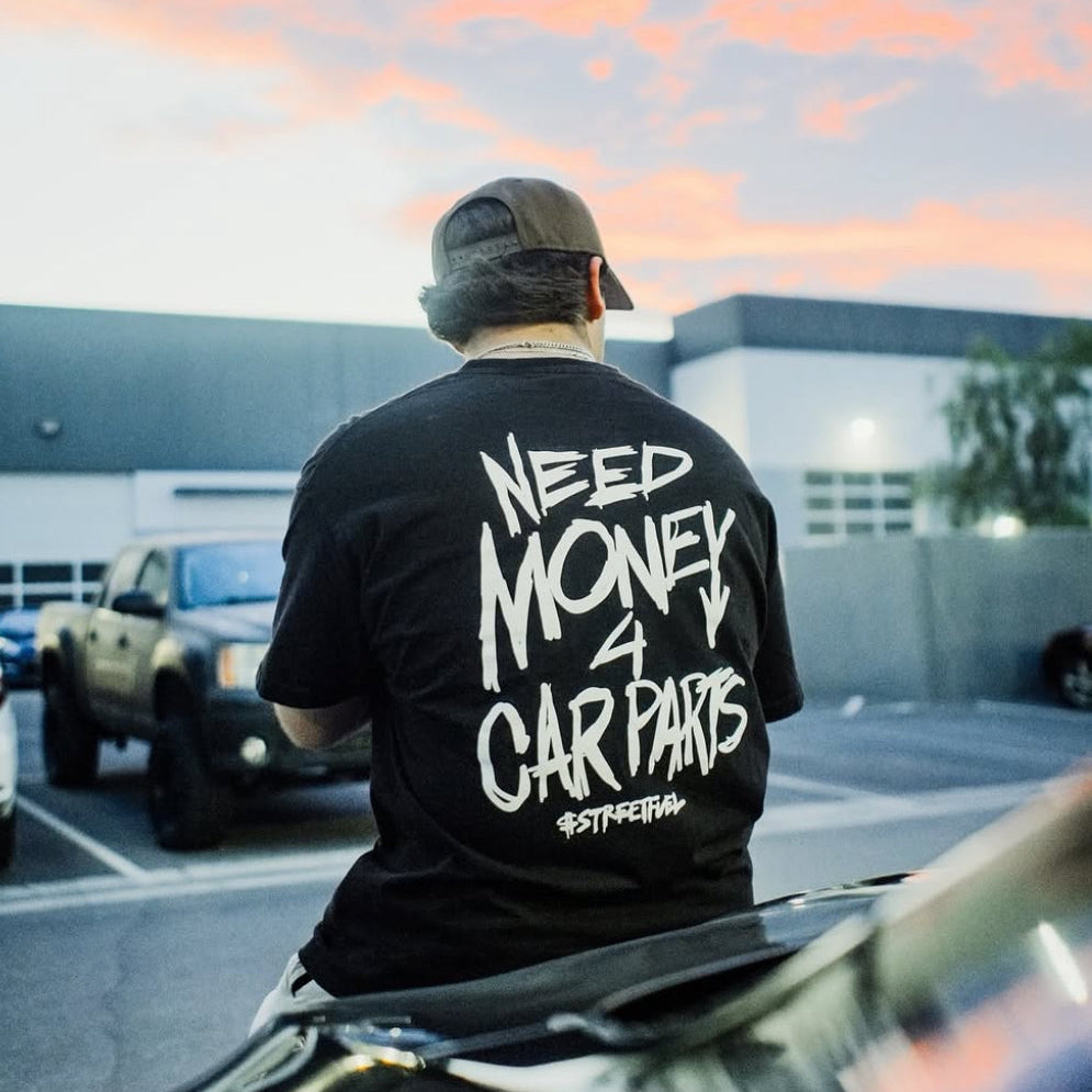 Person wearing Need Money For Car Parts t-shirt