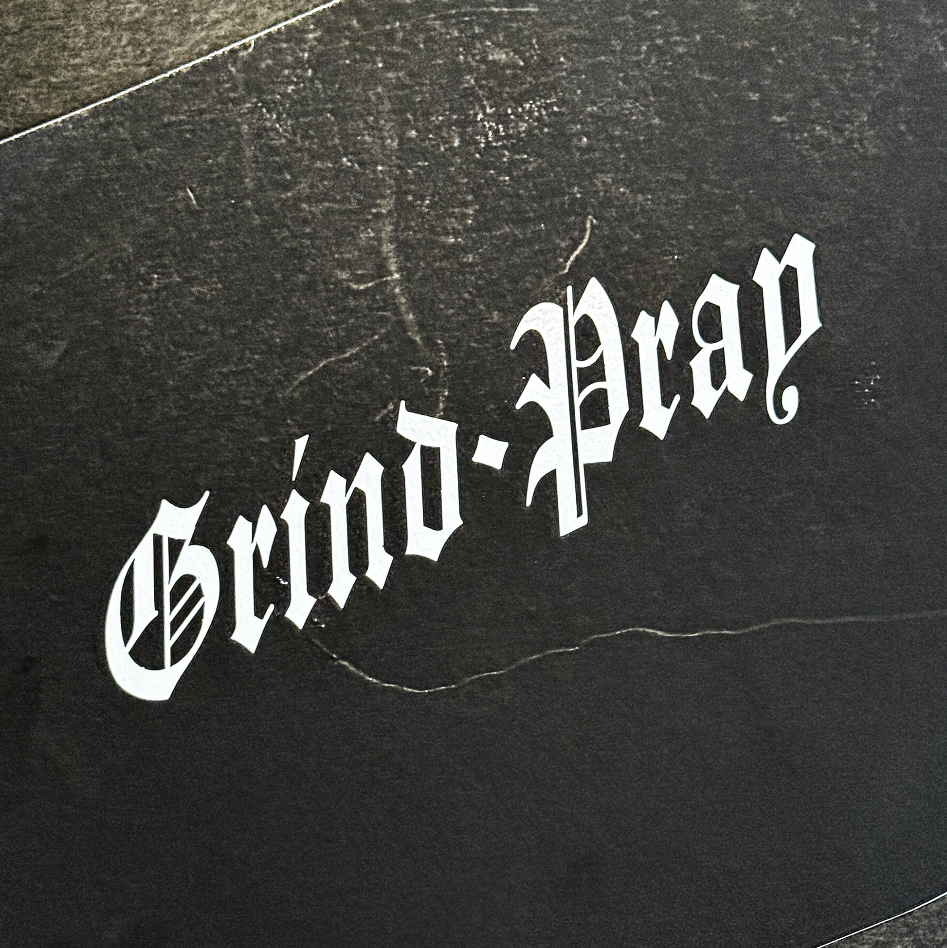 Grind and Pray die-cut vinyl sticker in gloss white by Streetfuel
