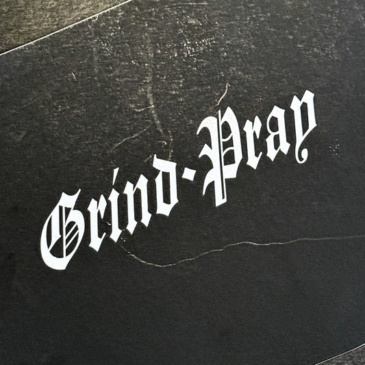Grind and Pray die-cut vinyl sticker in gloss white by Streetfuel